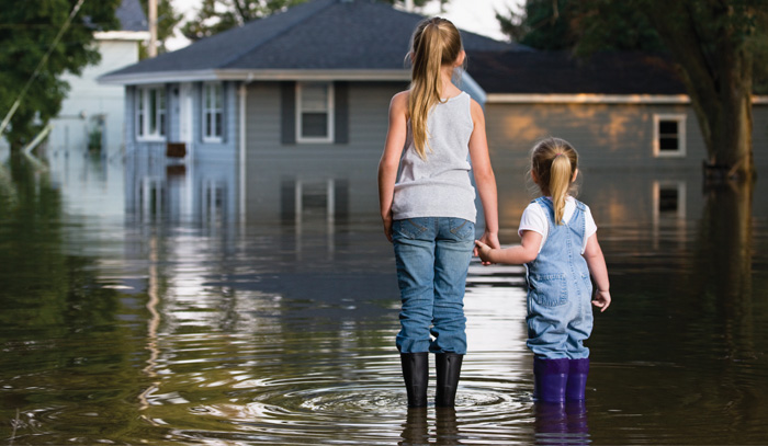 children standing in floodwater in Greensburg PA